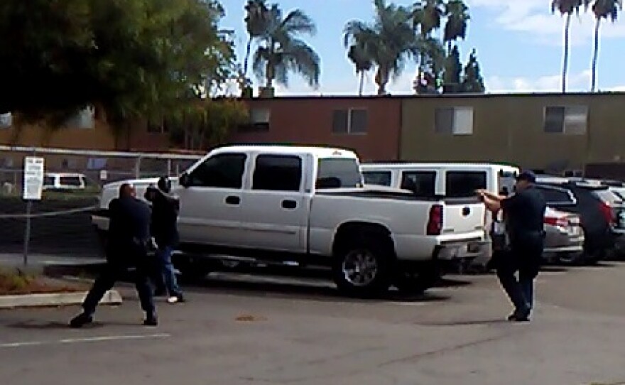 A still image from a cell phone video captured by a witness of two El Cajon police officers shooting an unarmed man, Sept. 27, 2016.