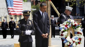 U.S. President Barack Obama (C) bows his head with New York Police Department officer Stephanie Moses and New York FIre Department firefighter Joseph Lapointe during a moment of silence with 9/11 first responders New York Police Department officer Stephanie Moses (L) and a firefighter during a wreath laying ceremony at Ground Zero after Osama bin Laden was killed on May 5, 2011 in New York City. 