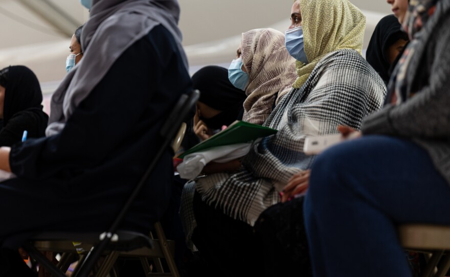 Afghan women listen to a lesson in an education center in a refugee camp at Holloman Air Force Base in New Mexico on Nov. 4, 2021. The Department of Defense and Department of Homeland Security's Operation Allies Welcome initiative aims to support and house Afghan refugees as they transition into more permanent housing in the U.S.