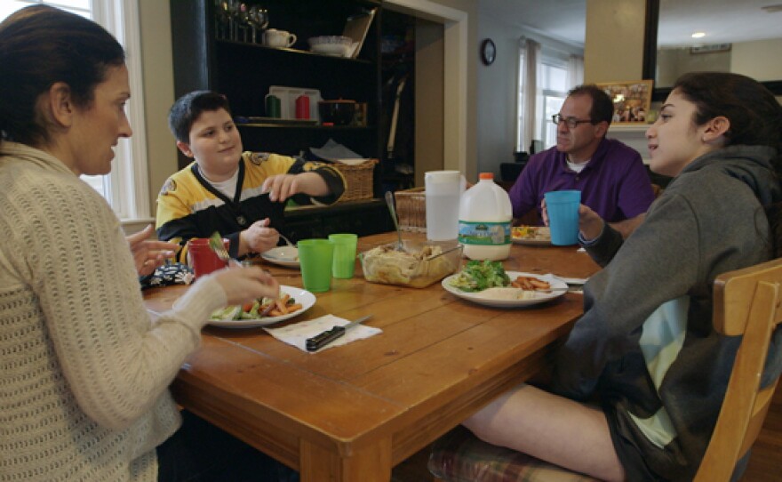 The Scavotto family sits down to dinner. Anthony (center left) was referred to a program for overweight kids at Boston Children’s Hospital after gaining 30 pounds in one year.