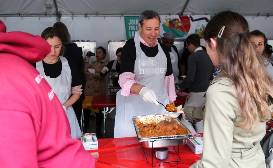 Volunteers serve curry at the Feeding the 5000 event.