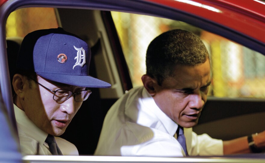 <p>President Obama and South Korean President Lee Myung-bak, wearing a Detroit Tigers baseball cap, check out the interior of the subcompact Chevrolet Sonic during their tour.</p>