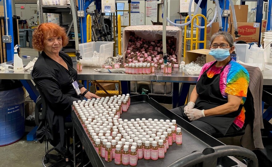 Alice Gomez and Maria Ramos work at Dr. Bronner's soap factory in Vista, Calif. The company is doing weekly coronavirus testing but still wants all its workers vaccinated.
