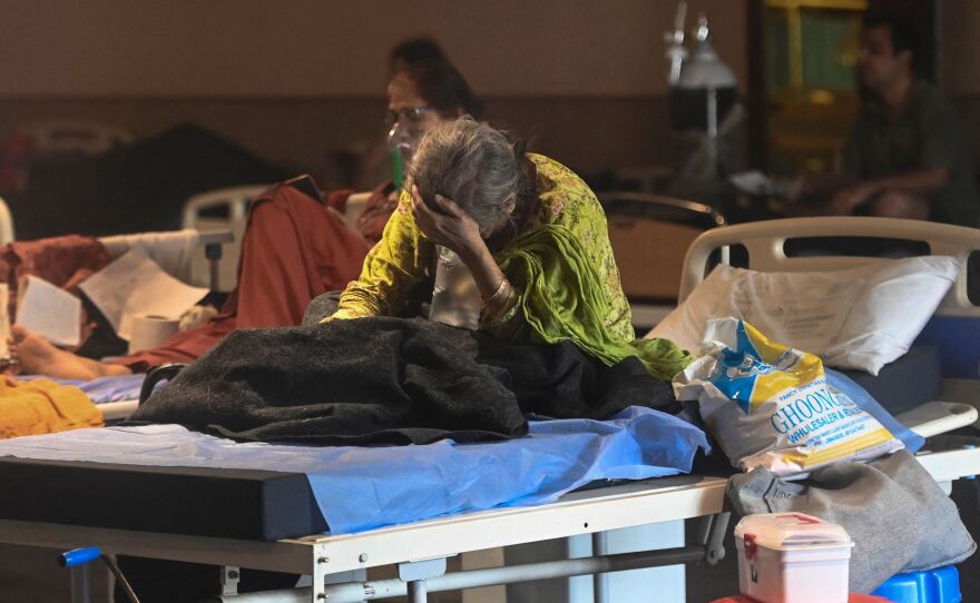 A patient rests inside a banquet hall converted into a COVID-19 ward on Tuesday in New Delhi.