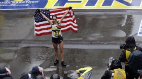 Desiree Linden, of Washington, Mich., celebrates after winning the women's division of the 122nd Boston Marathon on Monday, April 16, 2018, in Boston.