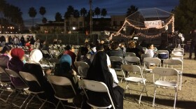 San Diego Unified students and families watch a musician play at the Celebration of Light, Dec. 14, 2016.