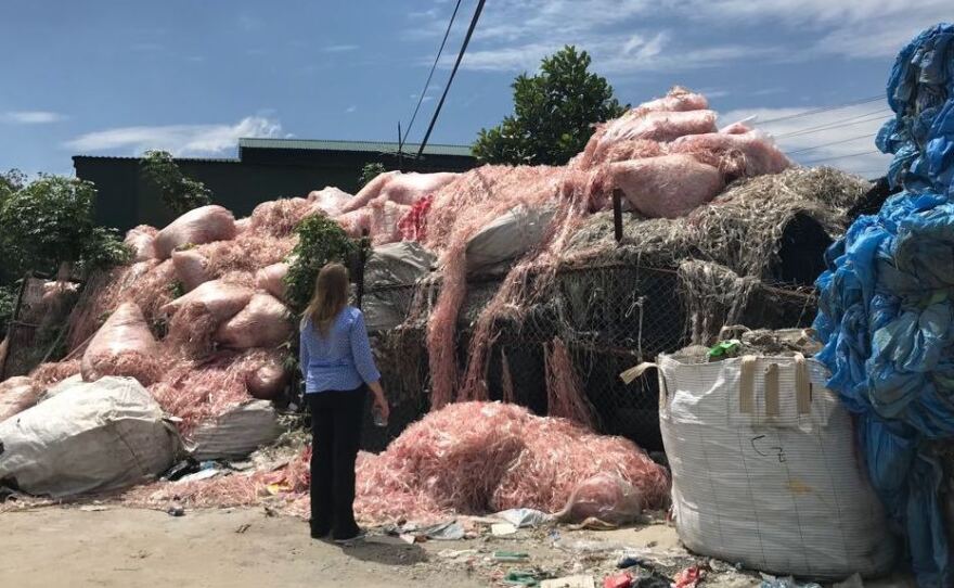 Waste engineer Jenna Jambeck of the University of Georgia surveys plastic waste in a southeast Asian village, where it will be recycled to make raw material for more plastic products. Jambeck advises Asian governments on how to keep plastic trash out of waterways.