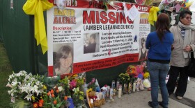 Community members place flowers on a memorial for Amber Dubois at Escondido High School on March 8, 2010.