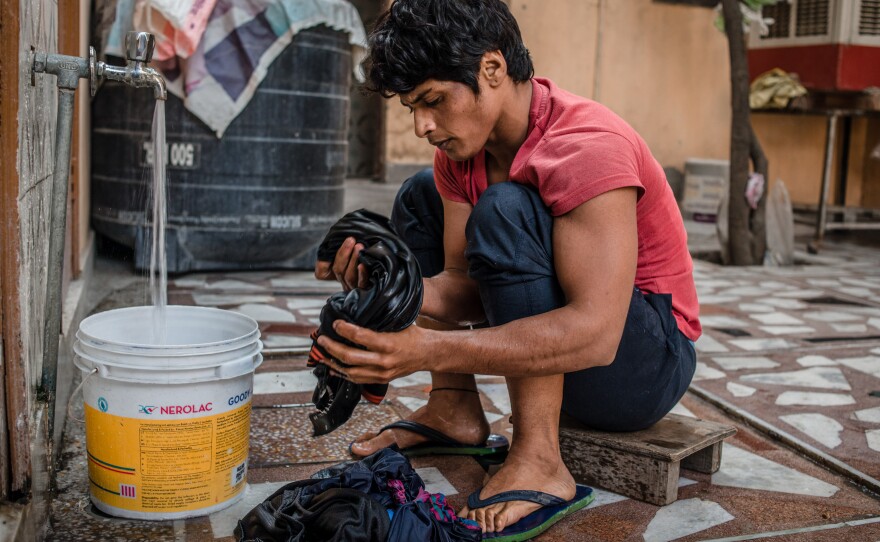 Neetu washes clothes in her rented room in Rohtak, India, where she lives (and trains) during the week. On weekends, she goes home to her village to be with her family.