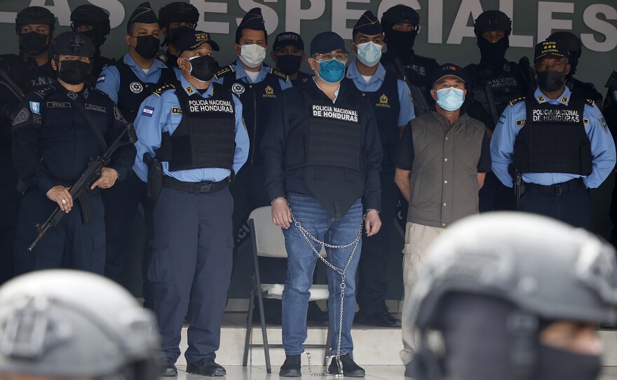 Former Honduran President Juan Orlando Hernández (center in chains), is shown to the press at the Police Headquarters in Tegucigalpa, Honduras, on Feb. 15.