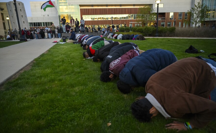 As the sun sets, Muslim protestors pray during a rally on campus at the University of Connecticut calling for the university to divest from companies they say are playing a role in the Israel-Hamas war. One person was arrested as several hundred people attended the event April 25, 2024.