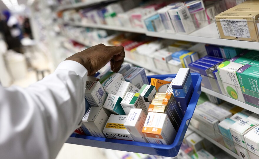 A pharmacist collects packets of boxed medication from the shelves of a pharmacy in London, U.K. A proposal announced by House Speaker Nancy Pelosi Thursday would allow the government to directly negotiate the price of 250 U.S. drugs, using what the drugs cost in Australia, Canada, France, Germany, Japan, and the United Kingdom as a baseline.