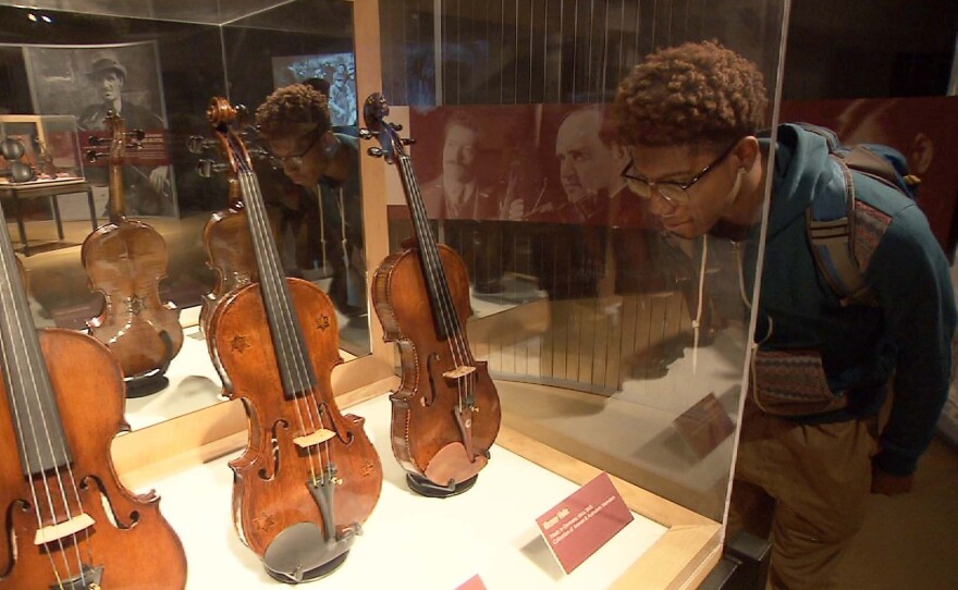 A student visiting the "Violins of Hope" exhibit at the Maltz Museum of Jewish Heritage in Ohio.