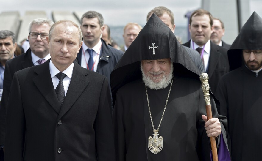 Catholicos Karekin II (R, front), the supreme head of the Armenian Apostolic Church, and Russia's President Vladimir Putin walk to attend a commemoration ceremony marking the centenary of the mass killing of Armenians by Ottoman Turks in Yerevan, Armenia.