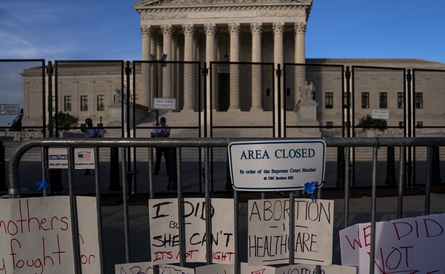 Signs left by abortion-rights supporters line the security fence surrounding the Supreme Court on June 28, after the court overturned Roe v Wade, ending the federal right to an abortion.