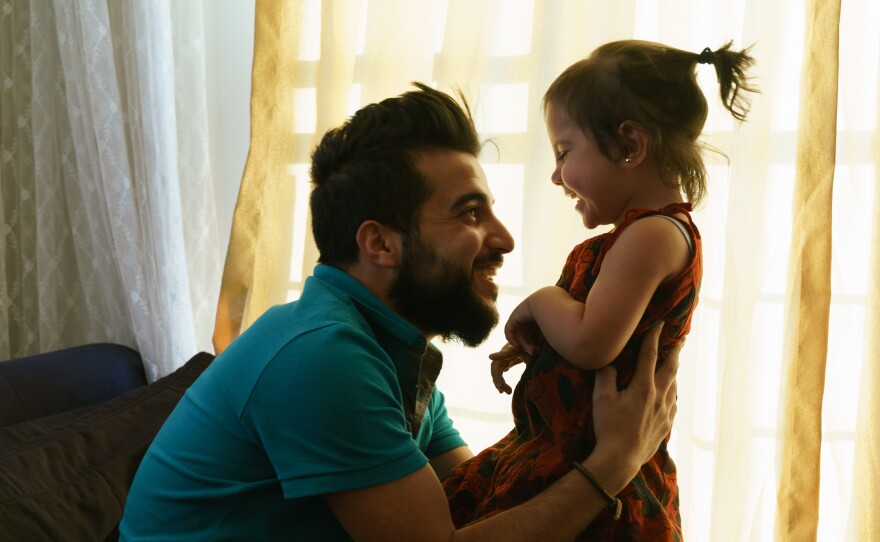 Aref al-Krez, a 24-year-old Syrian refugee living in Gaziantep, Turkey, plays with his daughter Perla, 2, who was born in Turkey. Turkey considers the refugees to be "guests" and it is extremely difficult to obtain the paperwork needed to build new lives.