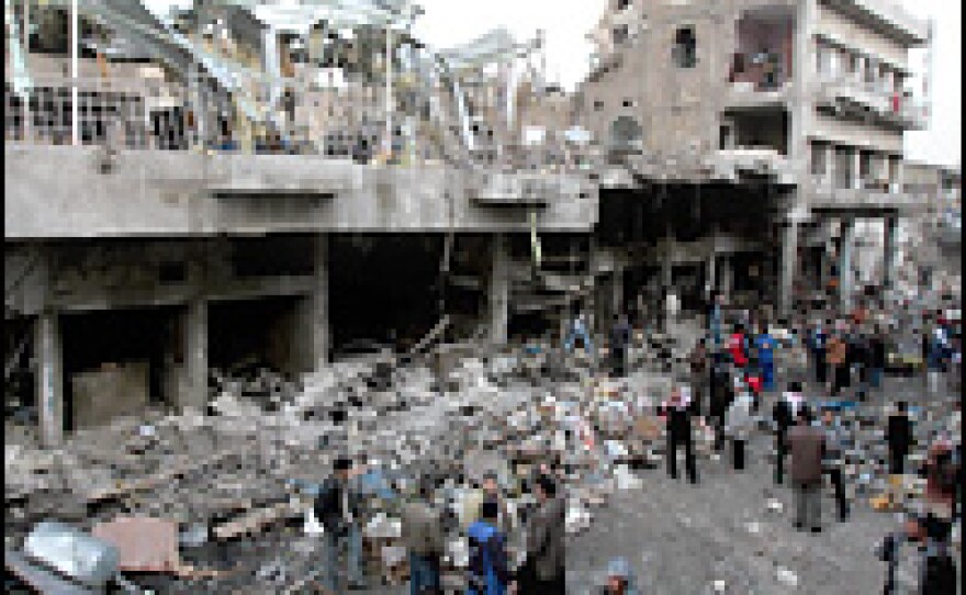 Iraqis inspect the destruction left by a suicide bombing on Feb. 3, 2007 in central Baghdad's al-Sadriya district.