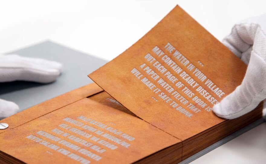 Tear out a page from The Drinkable Book and pour water through it. The built-in filter can wipe out bacteria.