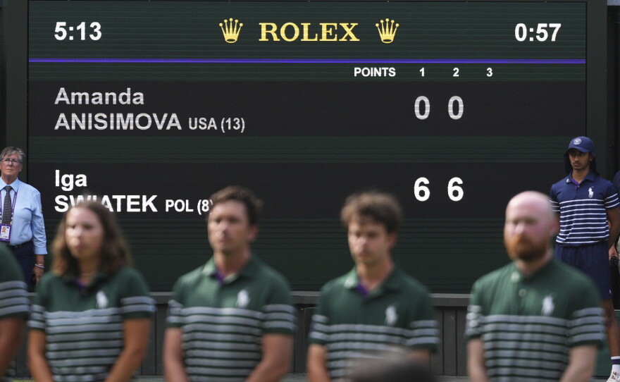 The scoreboard shows the results of the women's singles final match between Iga Swiatek of Poland and Amanda Anisimova of the U.S. at the Wimbledon Tennis Championships in London, Saturday, July 12, 2025.