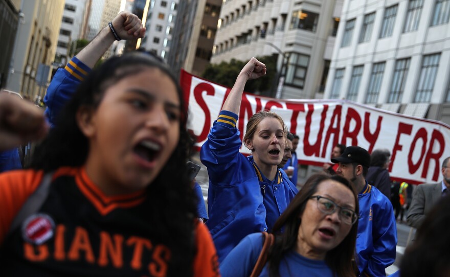 Protesters chant during a May Day demonstration outside a U.S. Immigration and Customs Enforcement office in San Francisco on Monday. Thousands are expected to take to the streets across the United States to participate in May Day demonstrations.