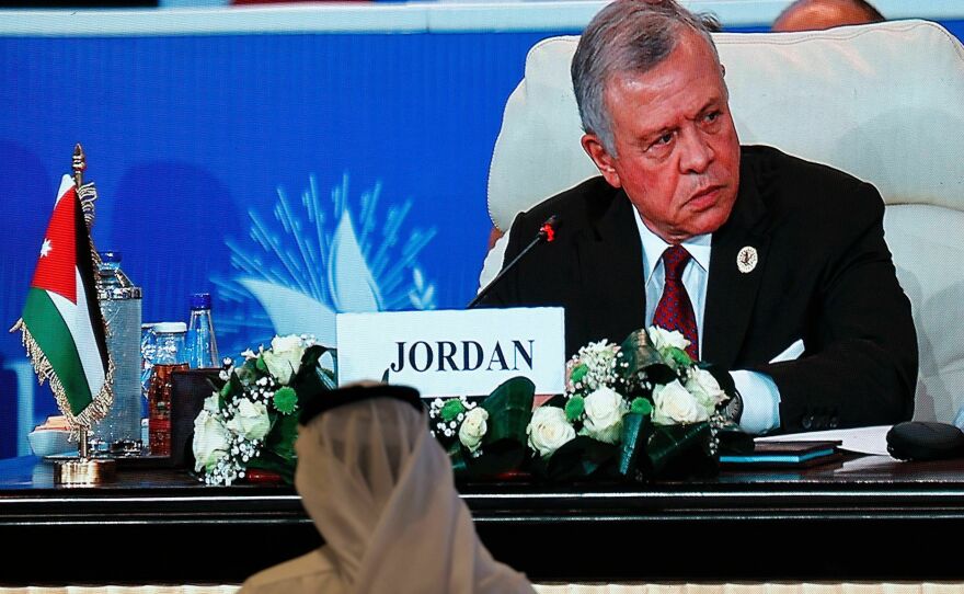 Jordan's King Abdullah is seen on a large screen at a peace summit hosted by the Egyptian president in the New Administrative Capital east of Cairo, on Saturday.