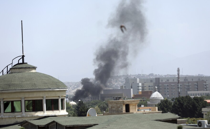 Smoke rises next to the U.S. Embassy in Kabul, on Sunday. Taliban fighters have entered the outskirts of the Afghan capital, further tightening their grip on the country.