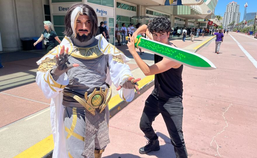 Carlos Vera Vandal, dressed as Doctor Strange from the video game "Marcel Rivals," poses with a friend outside San Diego Comic-Con on Preview Night, July 23, 2025.