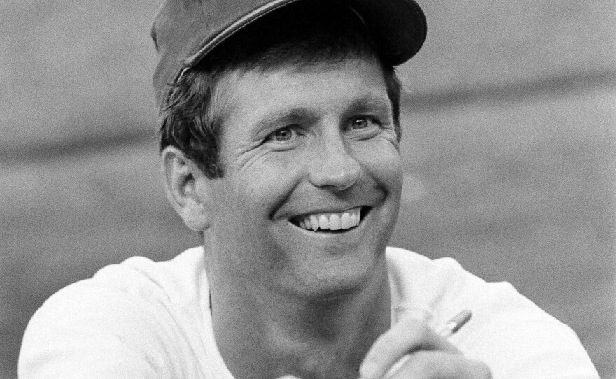 Lefthander Tommy John of the Los Angeles Dodgers signs an autograph before a game on Aug. 12, 1977.