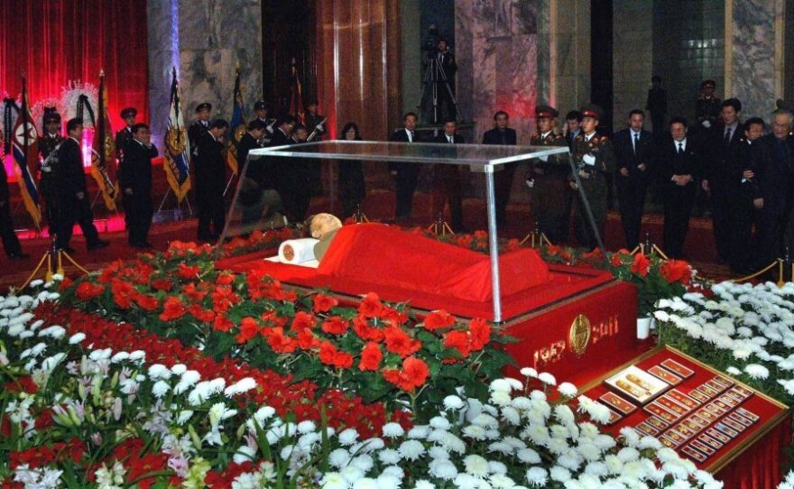 The body of North Korean leader Kim Jong Il is seen as people pay their respects in Pyongyang on Dec. 20. South Korean analysts say power in the North is likely to be vested in a new leadership group, with Kim's son Kim Jong Un as its public face.