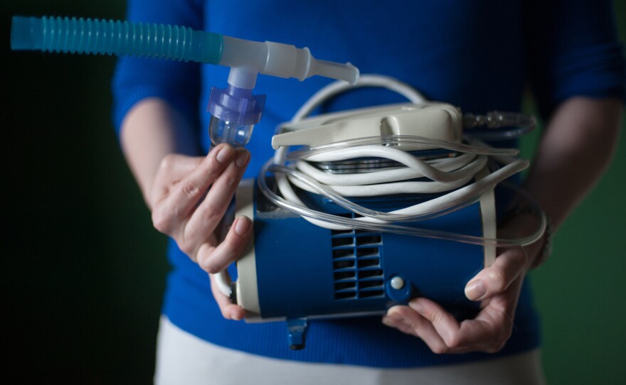 Virginia Rady, 28, holds her old nebulizer at her home in Dallas. Rady was diagnosed with chronic persistent asthma at the age of two. She underwent a series of three outpatient surgeries between Dec. 2012 and Feb. 2013 for a procedure known as bronchial thermoplasty. She says the procedure has changed her life, allowing her remove her nebulizer from her bedside.