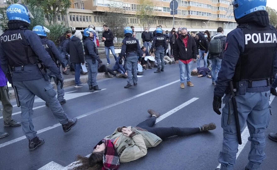 Climate activists try to block traffic on a main road leading to La Nuvola, the convention center where the G-20 summit is taking place.