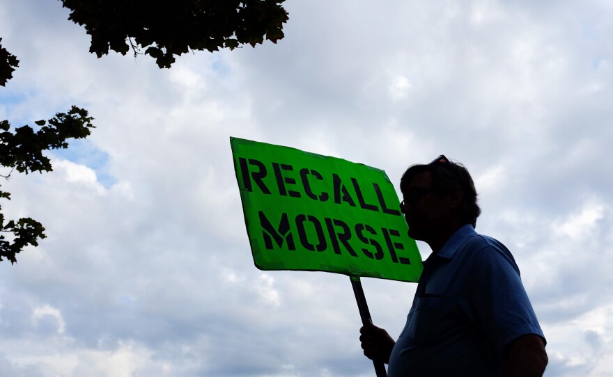 A man holds a sign advocating the recall of state Sen. John Morse in Colorado Springs, Colo., in September. Morse and a second state senator who backed the state's new gun control measures were recalled during a special election that month.