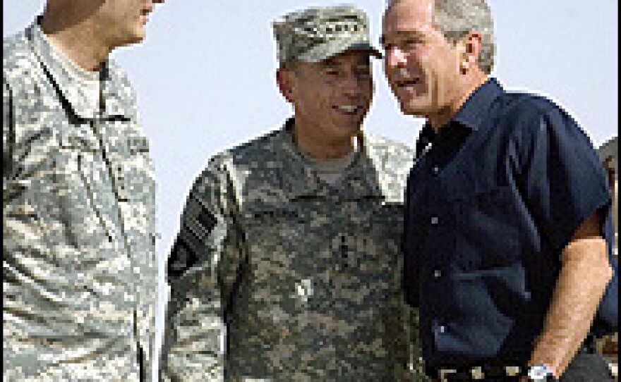 President Bush speaks with Gen. David Petraeus (to his left) at Al-Asad Air Base in Iraq.