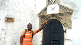 George Mwinnyaa on his visit to the slave castle at Cape Coast in his homeland of Ghana. The door leads to the cells where captives who were resistant were held prior to being sent over the ocean as slaves.
