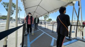 Patients waiting in line for a COVID-19 vaccine outside a vaccination super station in Chula Vista, Calif. Feb. 5, 2021.