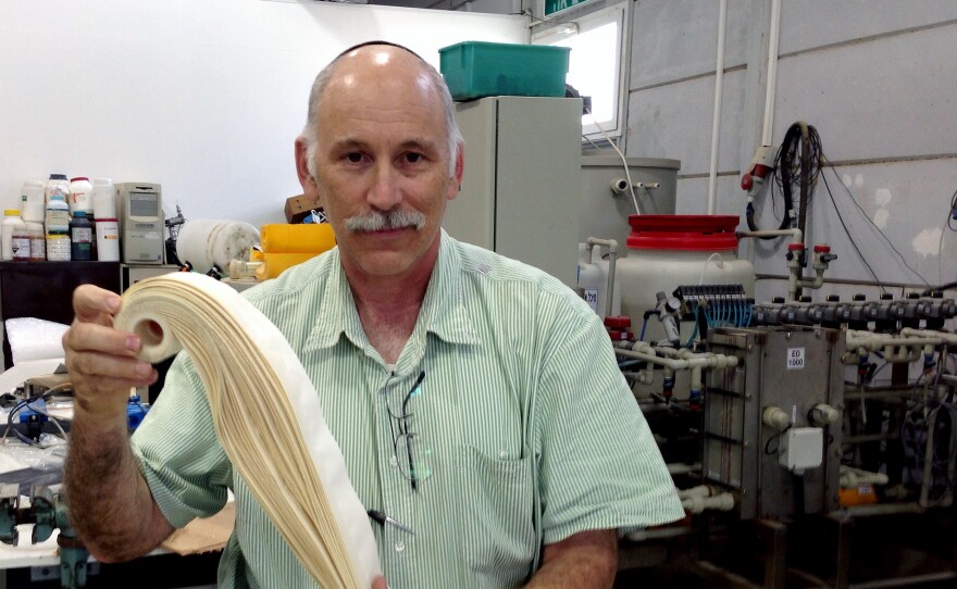 Prof. Jack Gilron displays a sample of the tough membrane system, considered the "workhorse" of Israel's desalination efforts, at Ben Gurion University's Institute for Water Research in Israel.