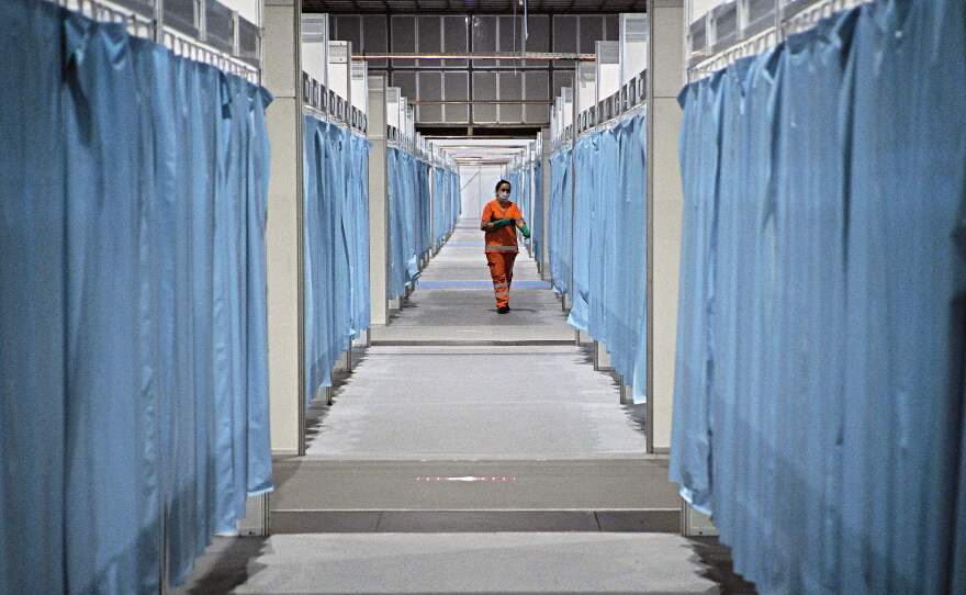 A custodian walks down the corridor of a field hospital set up for COVID-19 patients in Rio de Janeiro. Brazil has emerged as a new hot spot of the coronavirus, which in a span of just three months has reached virtually every country in the world.