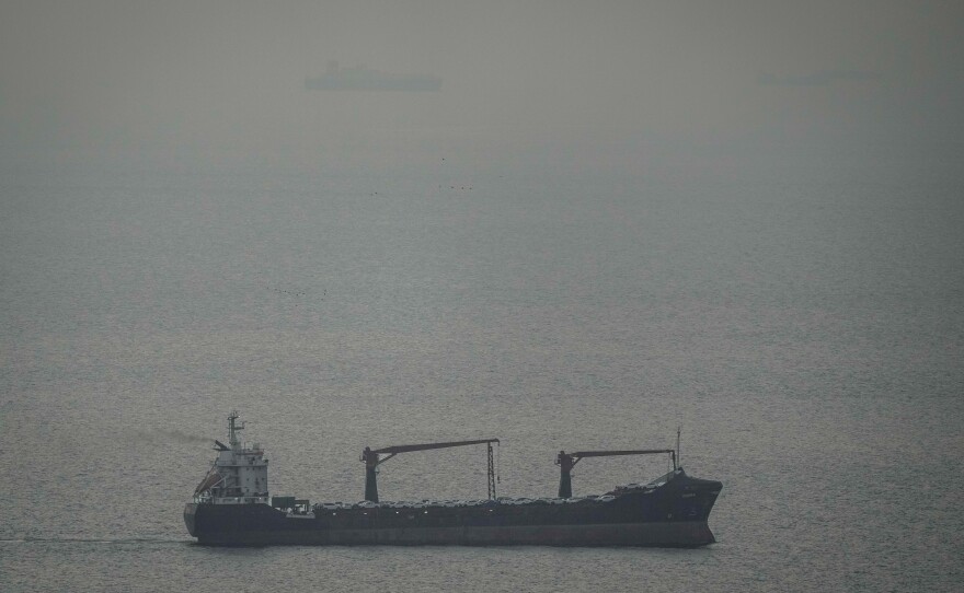 A cargo ship carrying vehicles sails through the Arabian Gulf toward the Strait of Hormuz in the United Arab Emirates, Sunday, March 22, 2026.