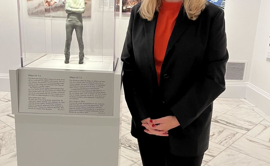 <em>One Life: Maya Lin</em> curator Dorothy Moss poses with Lin's portrait, commissioned by the National Portrait Gallery from artist Karin Sander in 2014.