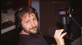 Thomas Fudge poses in front of the KPBS microphone in this undated photograph. Fudge is retiring after 30 years at KPBS.