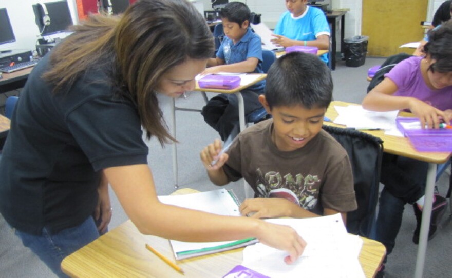 Teacher Annie Bhatnager helps a student with an assignment in the Newcomer class during the first week of school.