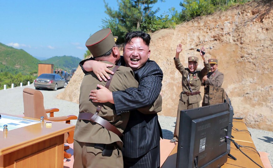 This picture taken on July 4, and released by North Korea's official Korean Central News Agency on July 5, shows North Korean leader Kim Jong Un celebrating a successful test-fire of the intercontinental ballistic missile Hwasong-14.
