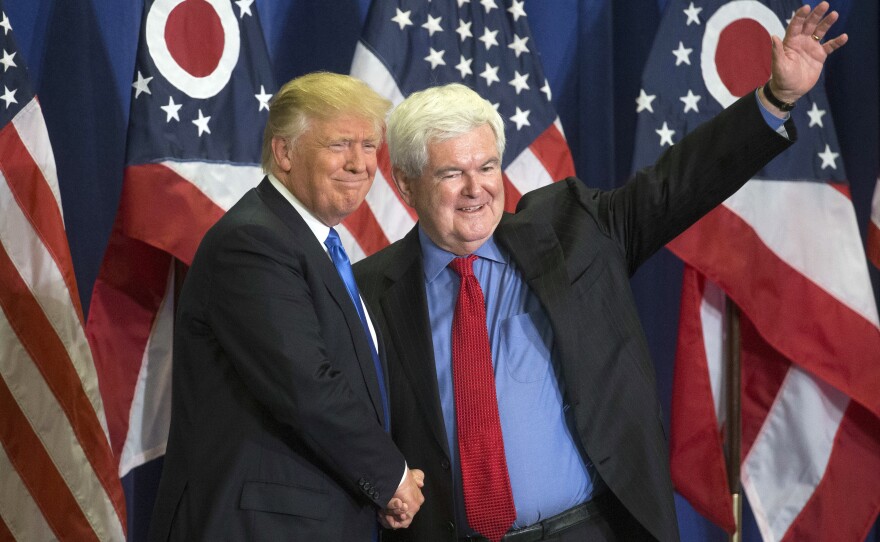 Former House Speaker Newt Gingrich joins then-presidential candidate Donald Trump on stage.