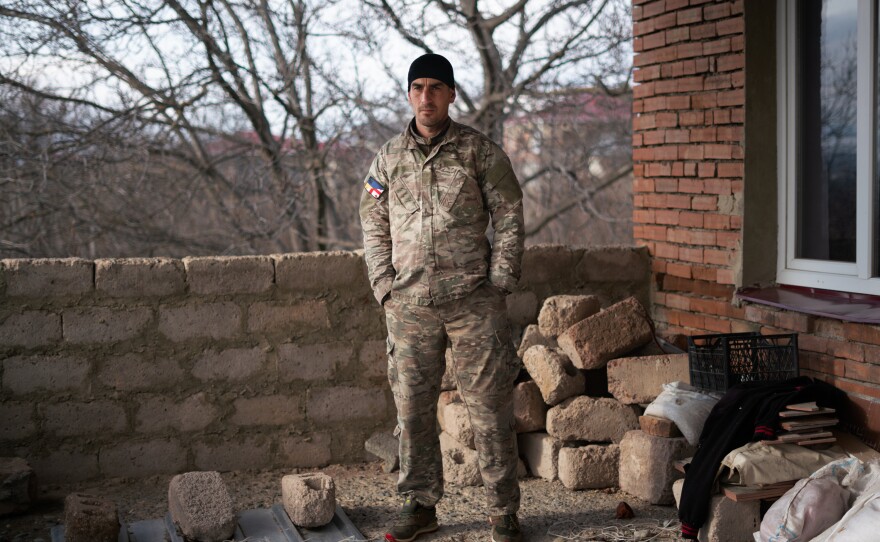 Giorgi Kasradze can see across the boundary with South Ossetia from the second floor of his home in Ergneti.