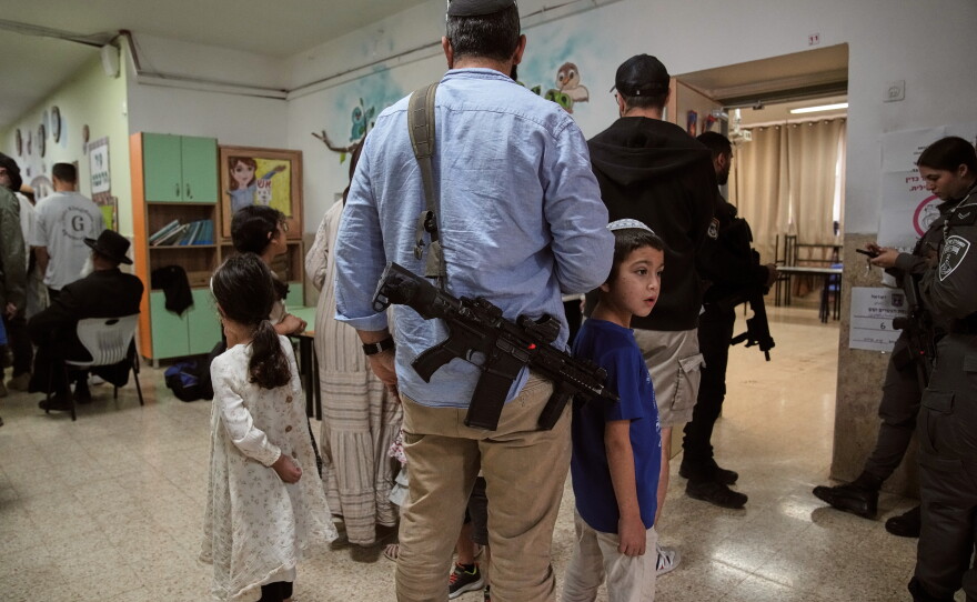 Israeli settlers line up to vote at a school serving as a polling station during Israel's general election in the settlement of Kiryat Arba, in the occupied West Bank, Tuesday, Oct. 27, 2026.