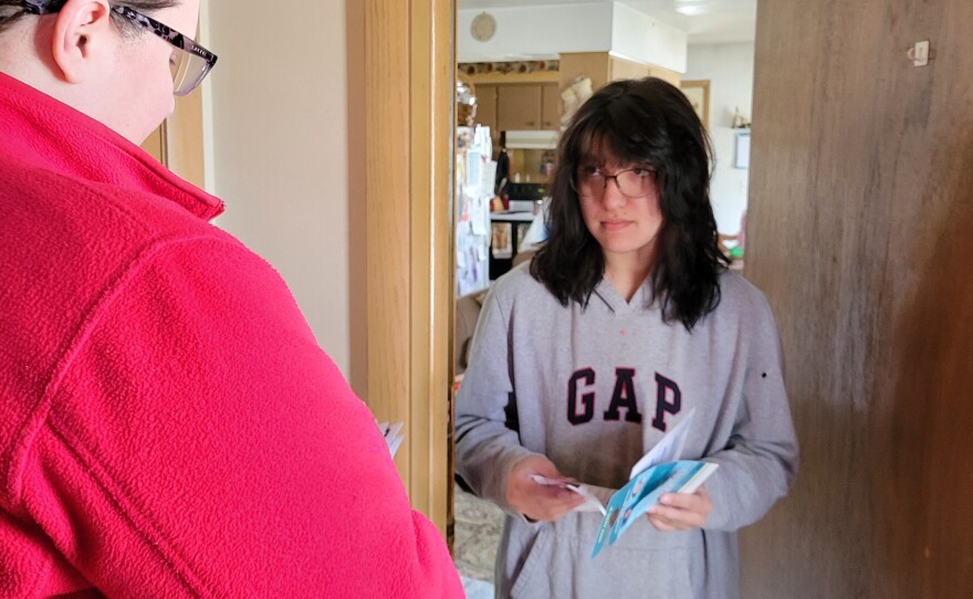 Biden campaign volunteer Sarah Harrison speaks with voter Autumn Dietscher on March 16 about Waukesha School Board elections and Wisconsin's presidential primary.