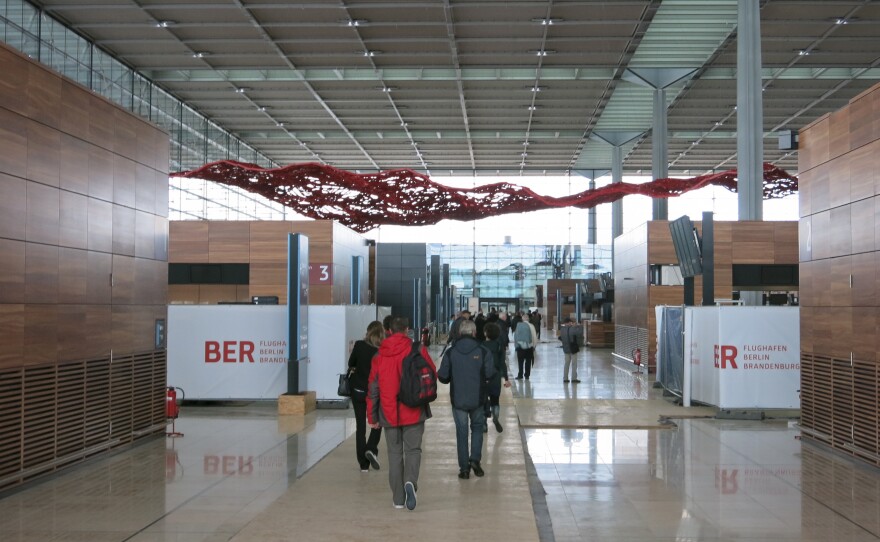 Tour groups walk through the halls of the unfinished airport. The tours cost about $11 per person.