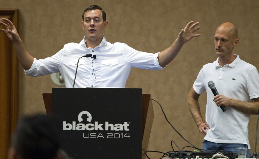 Chris Valasek (left) and Charlie Miller talk about hacking into vehicle computer systems during the Black Hat USA 2014 hacker conference in Las Vegas last August.
