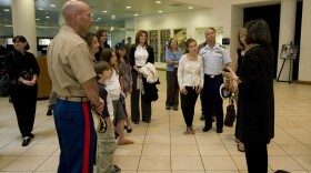Local military families tour the Museum of Photographic Arts with Executive Director Deborah Klochko.