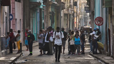 People line up in the street to buy bread in Havana, Cuba, Friday, March 13, 2026.